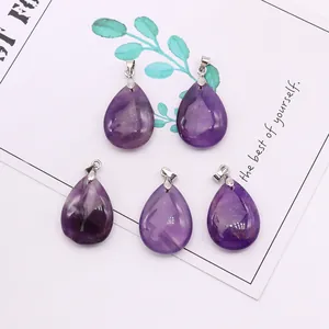 Macro shot of five teardrop amethyst pendants with silver clasps on a white display card