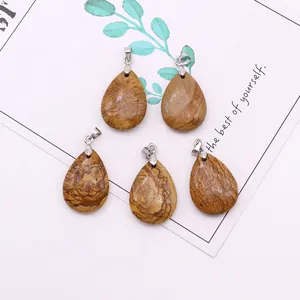Detailed view of five teardrop natural stone pendants with brown marble texture and silver bails