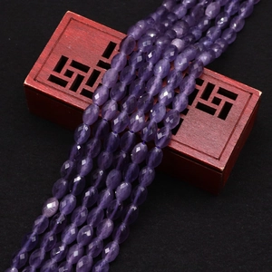 Close-up of faceted oval purple cat-eye stone beads for DIY jewelry making