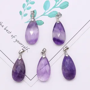 Macro detail of four faceted purple amethyst water drop pendants with silver metal clasps