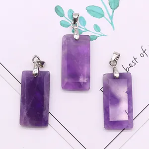 Macro shot of three faceted purple amethyst rectangle pendants with silver metal clasps