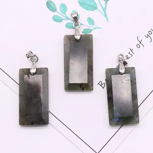 Detailed macro view of three rectangular labradorite pendants with silver bail connectors