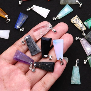 Trapezoid natural stone pendants with silver clasps held by hand for jewelry DIY