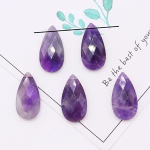 Macro view of faceted teardrop amethyst gemstones for DIY jewelry making and necklaces