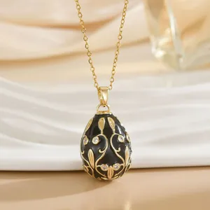 Faberge-style egg pendant necklace in black enamel and gold with clear crystals