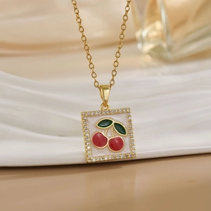 Macro shot of gold square pendant featuring a micro-set zircon border and cherry motif