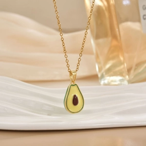 Minimalist avocado oil drip pendant necklace on gold chain with ceramic tray display