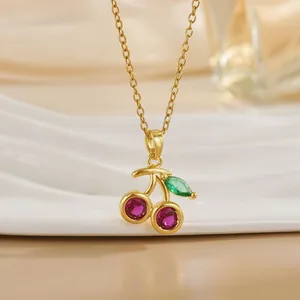 Elegant gold chain necklace with red cherry pendant featuring ruby-colored zircons