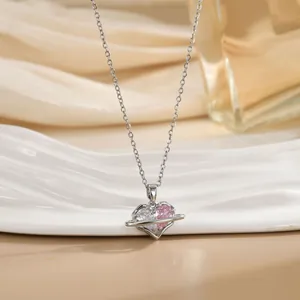 Detail of heart saturn pendant with pink and white zircon on a silver chain