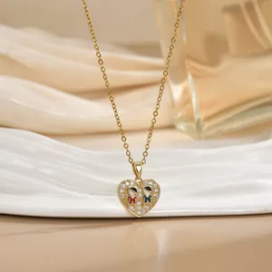 Elegant gold heart pendant necklace with shimmering crystals and small couple charms