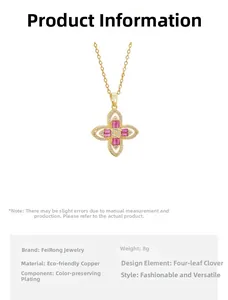 Vue détaillée du pendentif trèfle doré avec zircons rouges et cristaux blancs