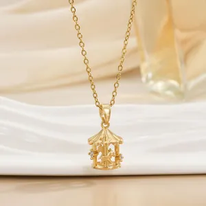 Detailed close-up of a gold merry-go-round pendant necklace with sparkling zircon accents