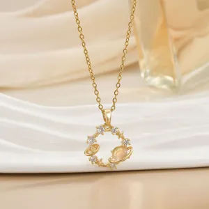 Detailed close-up of golden heart pendant with stars and celestial zircon elements