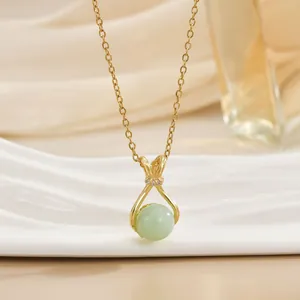 Detailed close-up of a green jade pendant necklace with gold chain and zircon accents