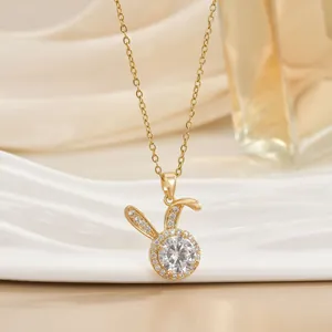 Detailed view of a golden rabbit pendant necklace with sparkling zircon stone setting