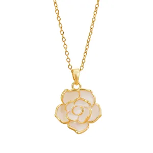 Elegant gold necklace featuring a detailed white camellia flower pendant on white background