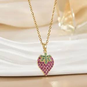 Elegant gold strawberry pendant necklace featuring pink and green zircon stones