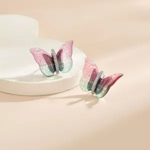 Détails de boucles d'oreilles papillon en dégradé avec des cristaux blancs étincelants