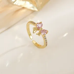 Elegant gold bow open ring with pink zircon heart stones and sparkling micro-pave crystals