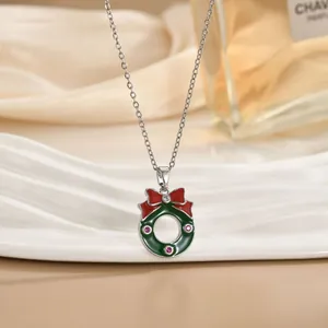 Dettaglio della collana ghirlanda di Natale con fiocco smaltato rosso e zirconi