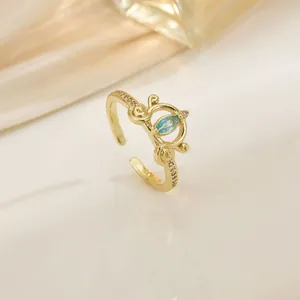Gold crown open ring featuring a blue marquise gemstone and white cubic zirconia accents