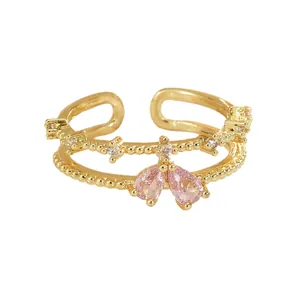 Bague dorée double couche réglable avec cristaux roses en goutte et accents de pavé