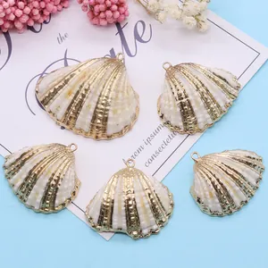 Detailed view of five white pearl shell pendants with gold plated edges for DIY jewelry