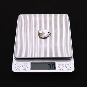 Dettaglio macro del ciondolo in perla barocca naturale dal peso di 3,0g sulla bilancia