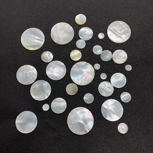Macro detail of natural iridescent white mother-of-pearl flat shell beads for DIY jewelry