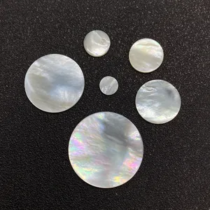 Natural white mother of pearl round flat shell beads with iridescent luster on black background