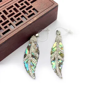 Natural abalone shell leaf pendant with crystal inlay and metal bail on white background