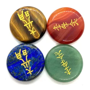 Polished natural stones including tiger eye and agate with golden Buddhist engravings