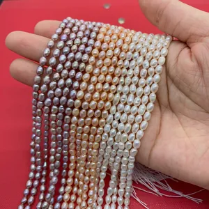 Detail of natural freshwater rice pearls in white pink and purple on red background