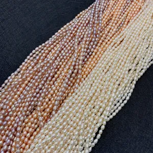 Macro detail of natural freshwater rice pearls in white, pink and purple on black texture