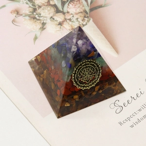 Orgone crystal pyramid with Sri Yantra symbol and layered natural gemstones stones