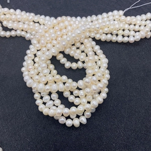 Macro detail of multi-layer natural freshwater pearl strands with milky white luster