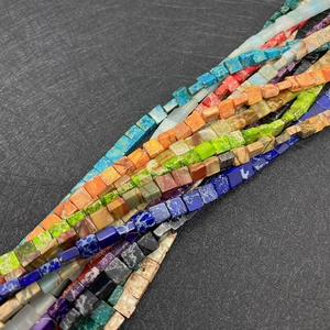 Macro view of 3x6mm square natural emperor stone beads in vibrant assorted colors