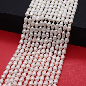 Macro detail of natural white freshwater baroque pearl strands with high luster texture