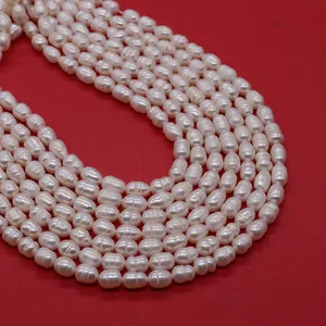 Macro detail of natural white freshwater baroque rice pearls with lustrous surface texture