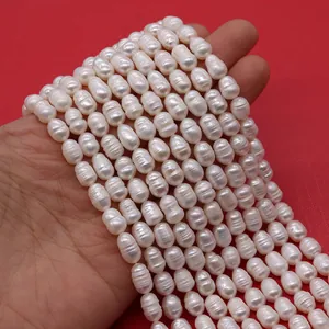 Close-up of natural white baroque freshwater pearls held in palm showing texture