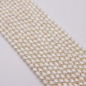 Macro detail of white baroque rice pearls showing natural luster and smooth surface texture