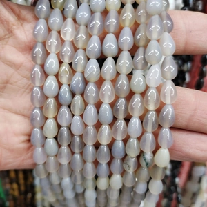 Macro detail of teardrop-shaped blue and white natural agate beads for DIY jewelry
