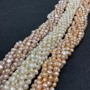 Natural freshwater baroque pearl strands in cream, pink, and orange colors, 5-9mm size