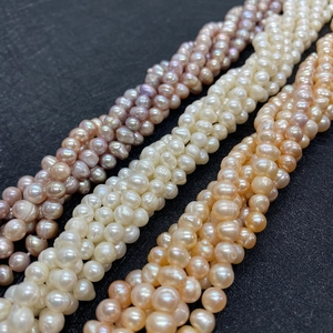 Close-up of natural freshwater pearl strands in white, lavender, and peach tones