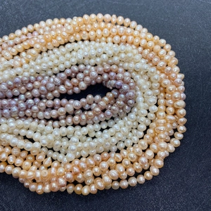 Macro view of multi-color natural freshwater pearls in white pink and purple tones
