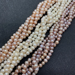 Macro view of multi-color AA natural freshwater pearls in white pink and purple for DIY jewelry