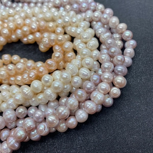Macro shot of natural freshwater pearls in white, champagne, and lavender with organic texture