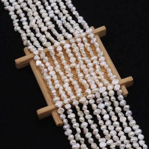 Macro view of natural freshwater baroque pearls with lustrous white finish on wood