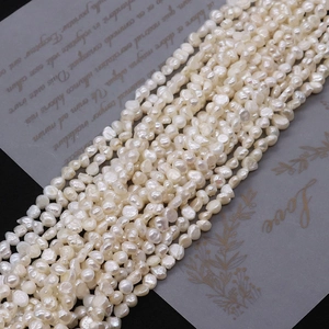 Macro detail of high-luster natural freshwater baroque pearl strands for DIY jewelry