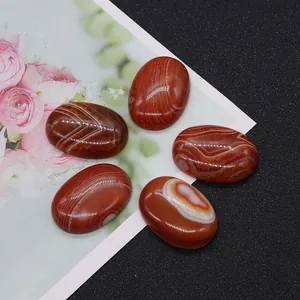 Detailed macro view of five oval striped red agate stones with natural polished textures